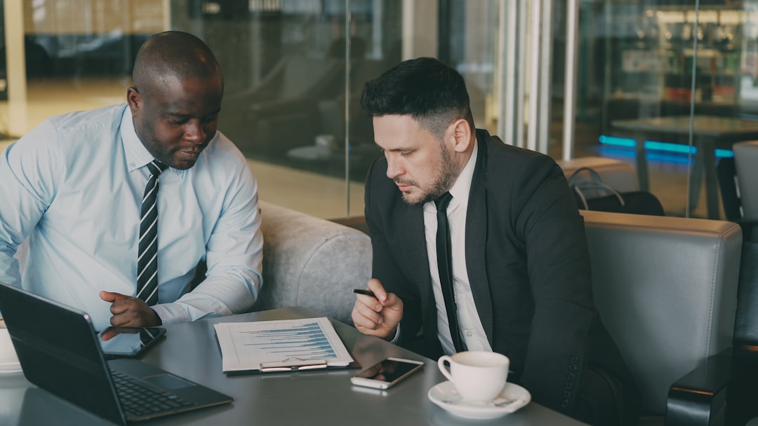 Two businessmen reviewing documents at a table